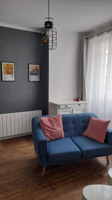 a living room with a blue couch in a room at Appartement T2 Rennes Saint Hélier in Rennes