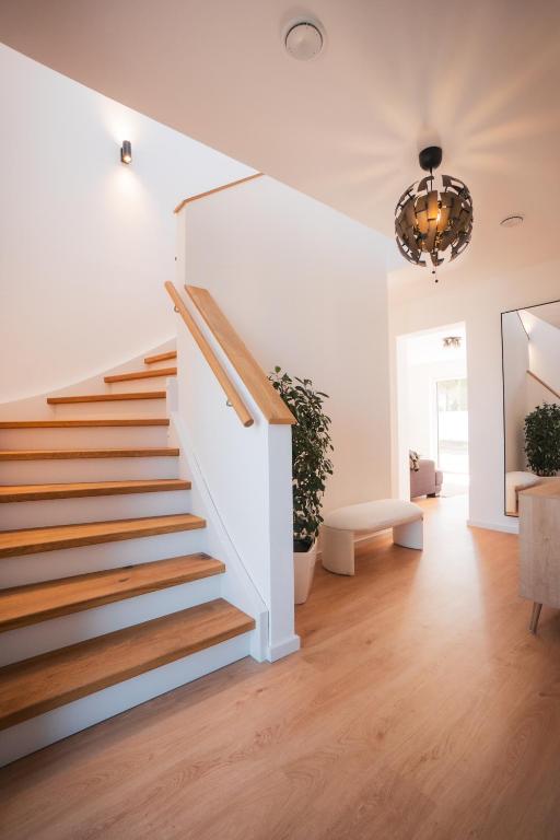 a staircase in a home with white walls and wood floors at Fernruh Eifel in Dahlem