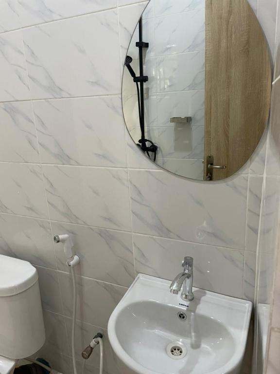 a bathroom with a sink and a mirror at Lloyd hotel in Benin City