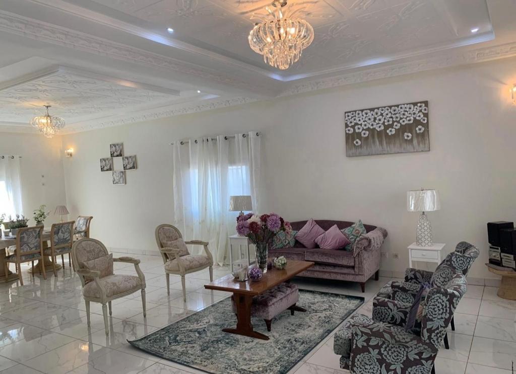 a living room with a couch and a table and chairs at Linda's Guest House in Rotouma