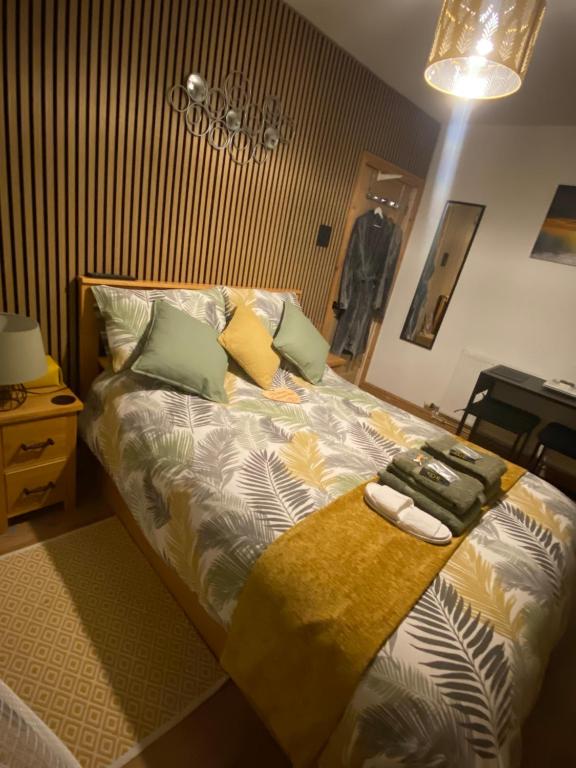 a bedroom with a large bed with pillows on it at Butterfly House in Blackwood