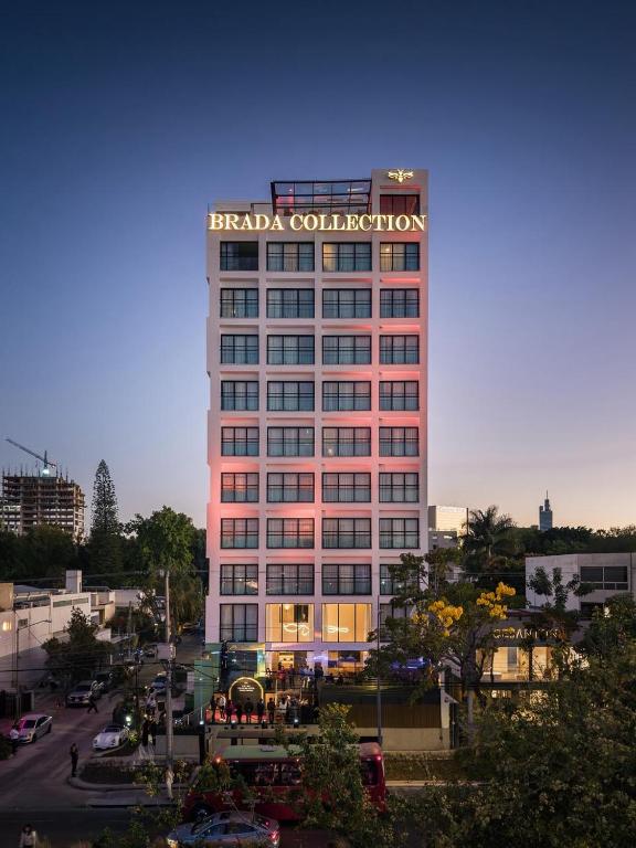 a tall building with a sign on top of it at Brada Collection Stays in Guadalajara