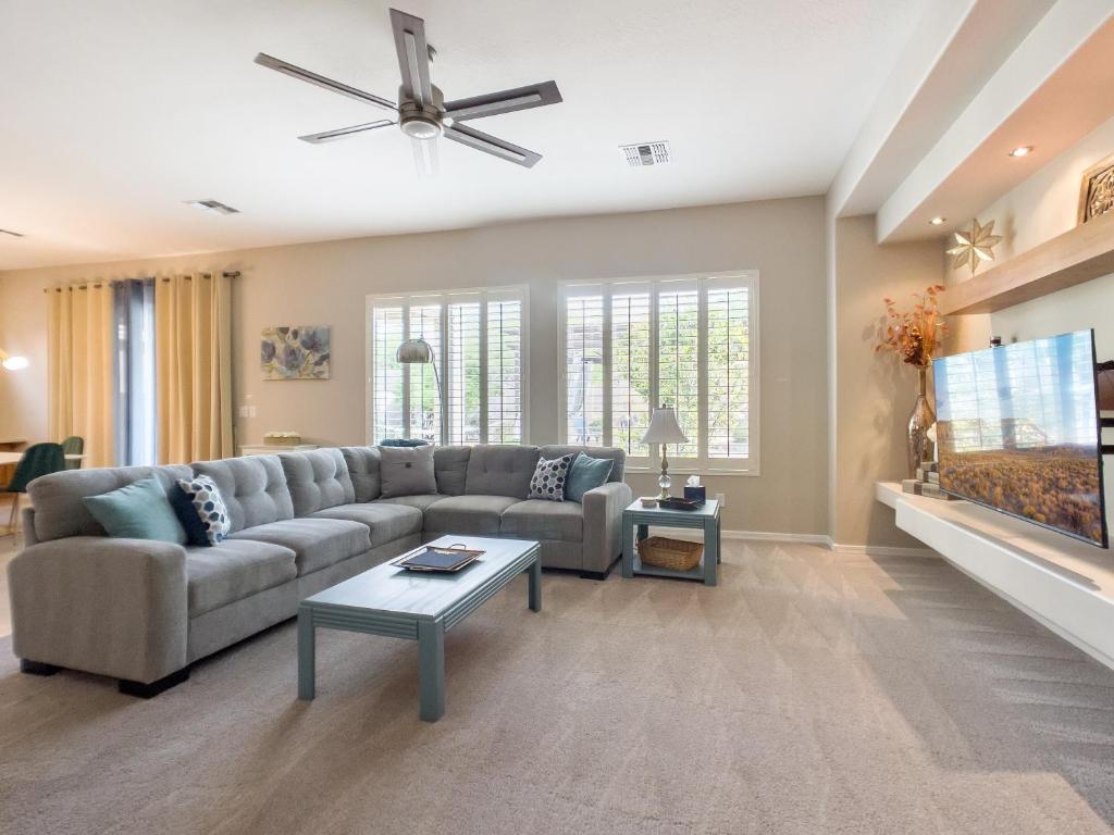 a living room with a couch and a tv at Anthem Allure in Phoenix