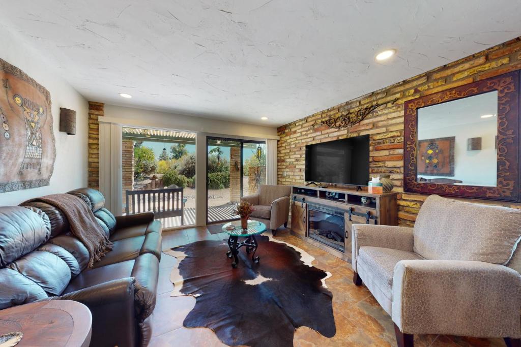 a living room with a couch and a television at Tranquil Trail #6 in Carefree