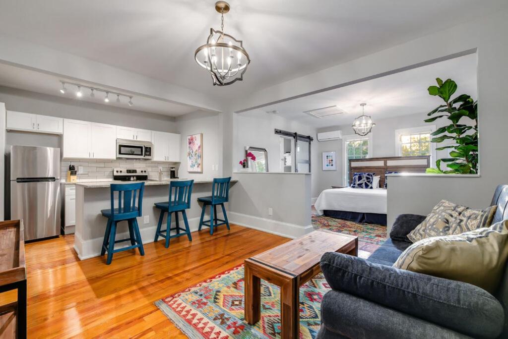 a living room with a couch and chairs and a kitchen at Historic Downtown Marble Falls- 2 Suite Combo 13 in Marble Falls
