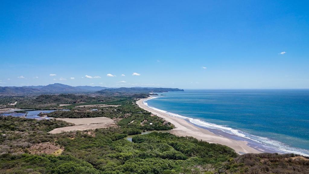 an aerial view of a beach and the ocean at Vista Popoyo 3BR Coastal Retreat with Surf & Mangrove Views in Popoyo