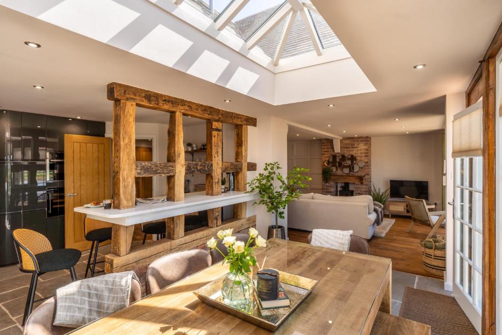 a living room with a table and chairs at Cedar Lodge Severn Stoke in Severn Stoke