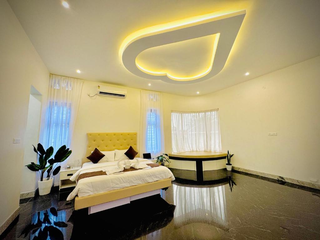 a large bedroom with two beds and a circular ceiling at Kings Castle in Varkala