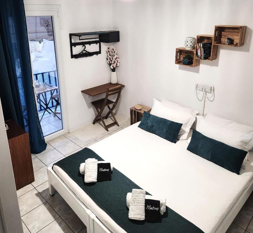 a bedroom with two beds and a balcony at Kato Yialos Paros in Parikia