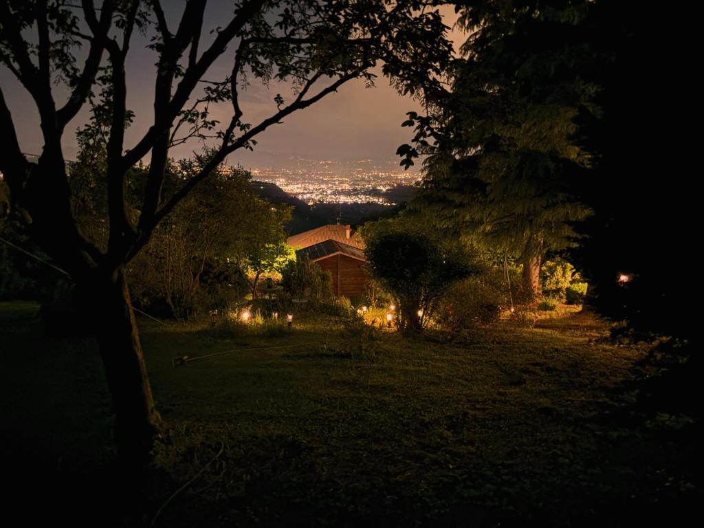 a view of a yard at night with a house at Casetta La Pera in Perarolo