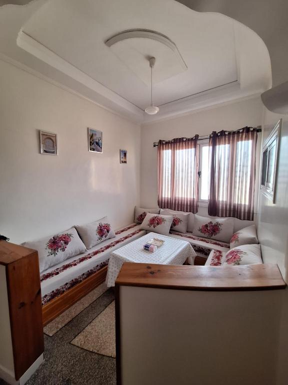 a living room with a couch and a table at Résidence Zaouit Aglou in Aglou