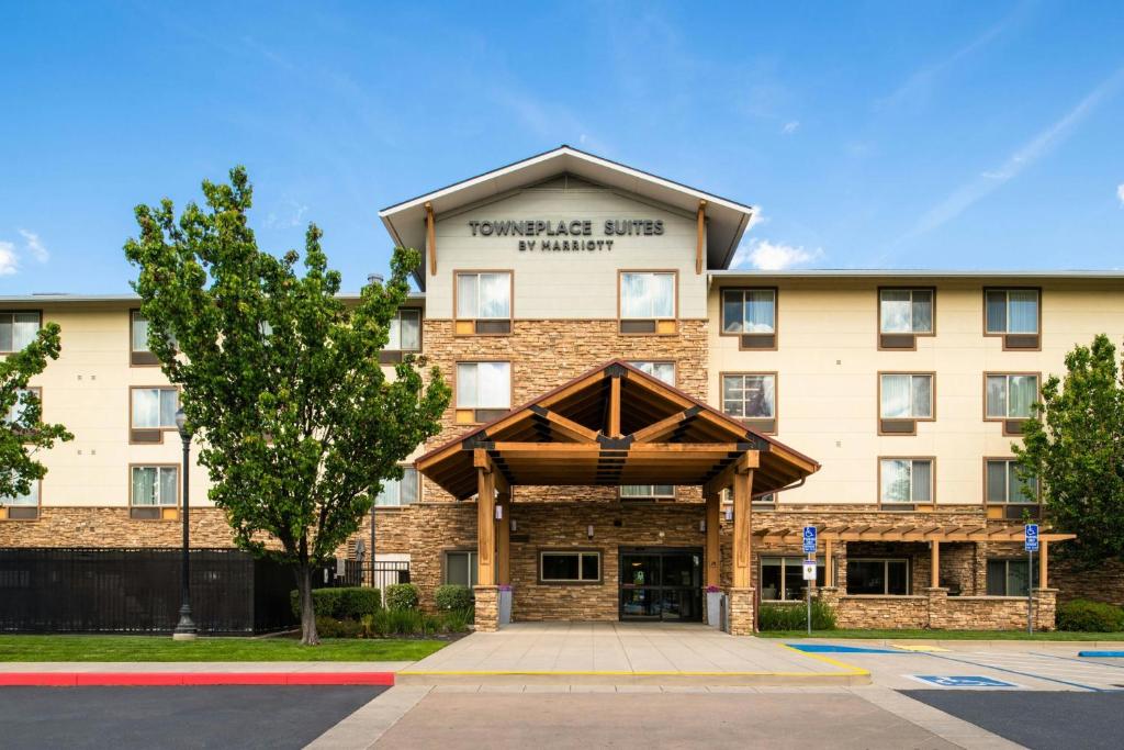 a hotel building with a sign that reads embassy gate hotel at TownePlace Suites Redding in Redding