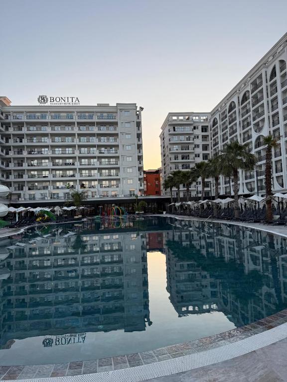 a large swimming pool in front of two buildings at Dengu Luxury Apartments in Golem