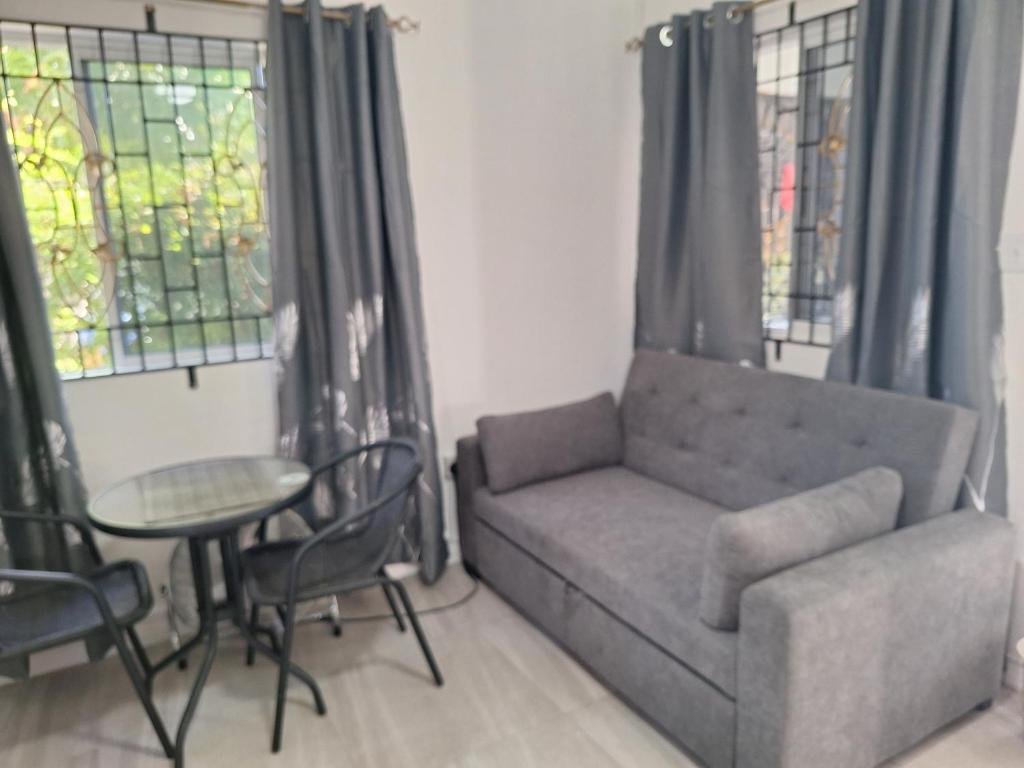 a living room with a couch and a table at 14 Zeneith Avenue in Harbour View