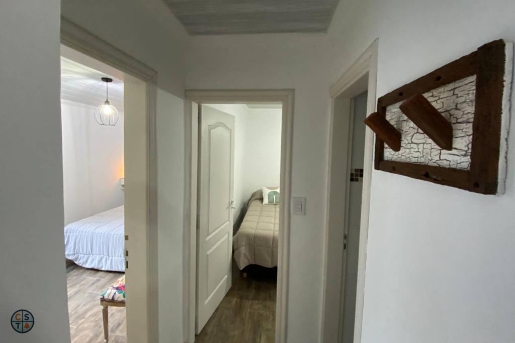 a hallway leading to a bedroom with a bed at SH Aparts Depto 1 in Coronel Suárez