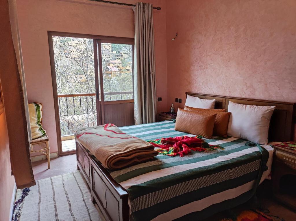 a bedroom with a large bed with a window at imlil in Imlil