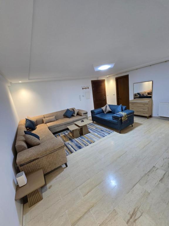 a large living room with two couches and a couch at Appartement Jasmin in Gabès