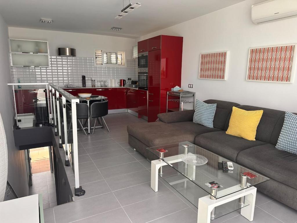 a living room with a couch and a kitchen at Casa De Pablo - Marbella Golf in Maspalomas
