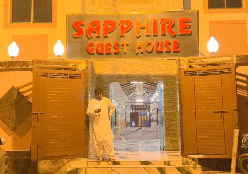 a man standing in front of a saphire guest house at Sapphire Guest House in Karachi
