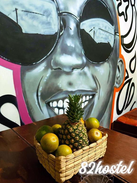 a basket of fruit with a man wearing sunglasses at 82Hostel in Bogotá