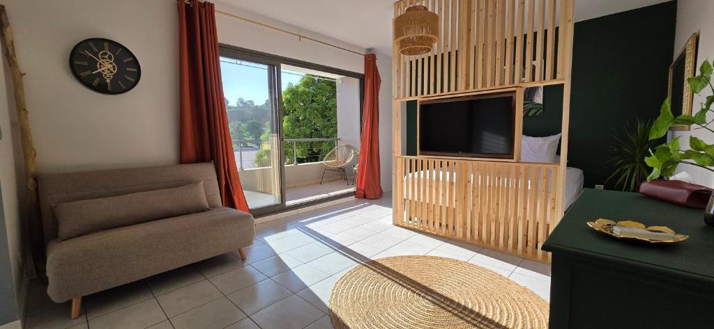 a living room with a chair and a television at Fare Iki in Papeete