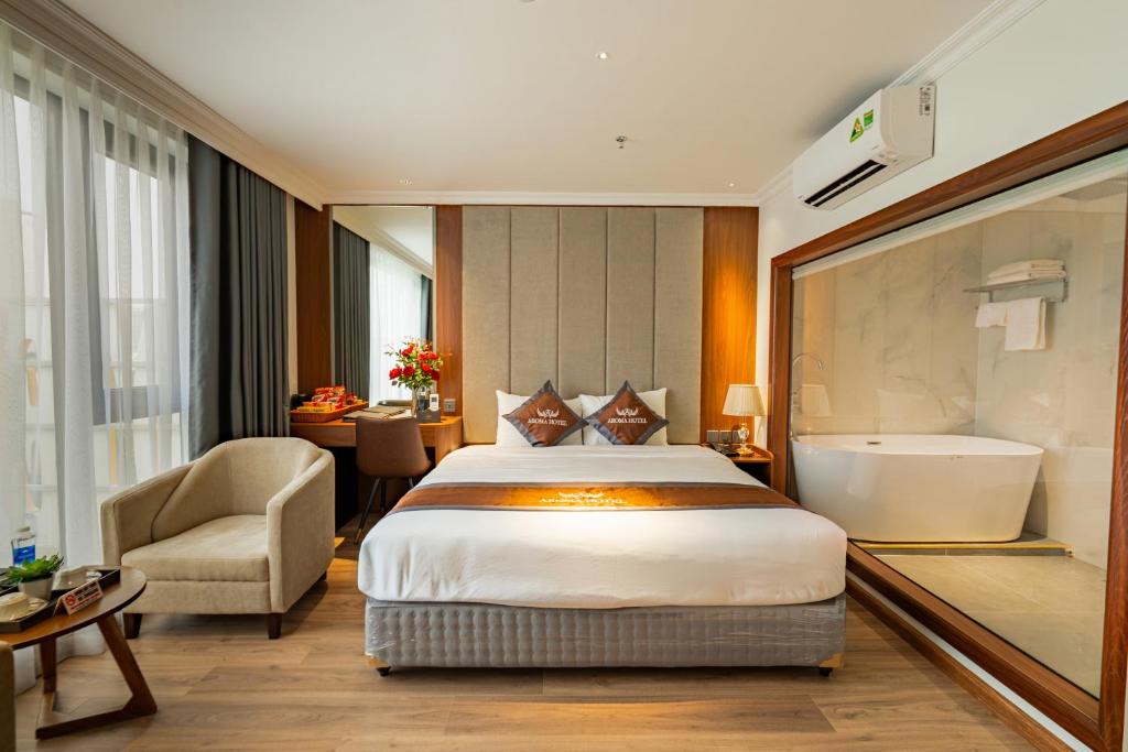 a hotel room with a bed and a bath tub at Aroma Hotel An Khánh in Vân Lũng