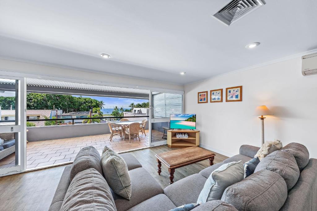 a living room with a couch and a table at Blue Lagoon Airlie Beach in Airlie Beach