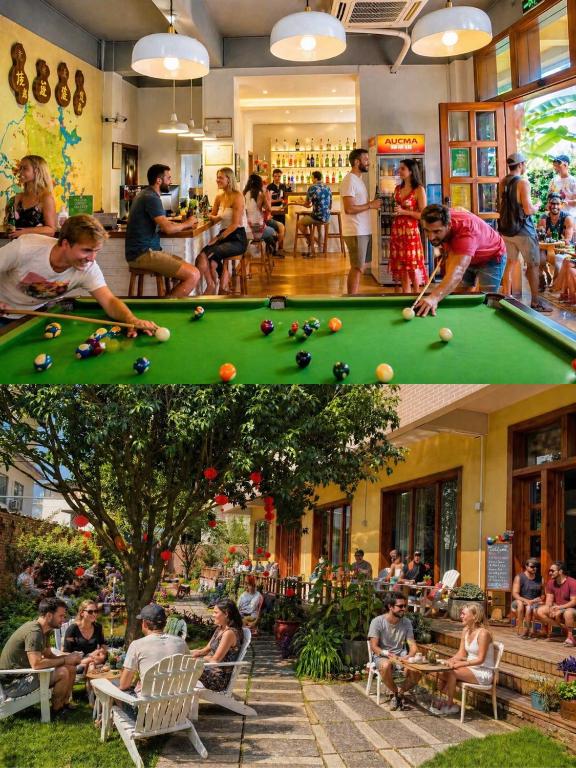 a group of people sitting around a pool table at Yangshuo Eden's Social Guesthouse - cozy garden courtyard & fresh craft coffee & night beers & outdoor activities in Yangshuo