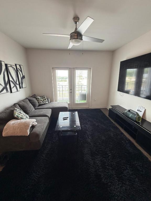 a living room with a couch and a ceiling fan at Cozy Comfortable Apartment in Atlanta in Atlanta