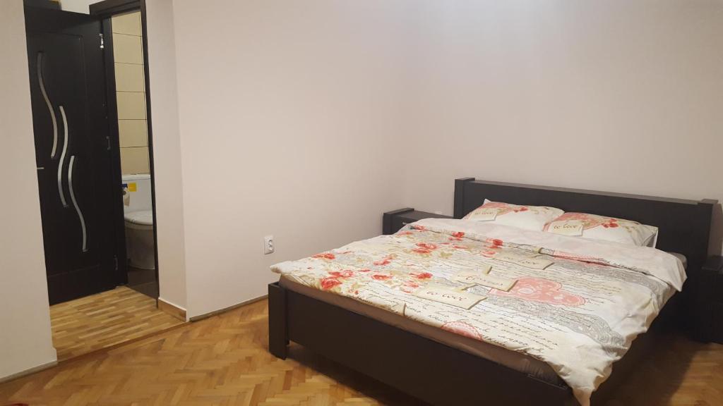 a bedroom with a bed and a bathroom at Studio Piata Sfatului - Brasov in Braşov