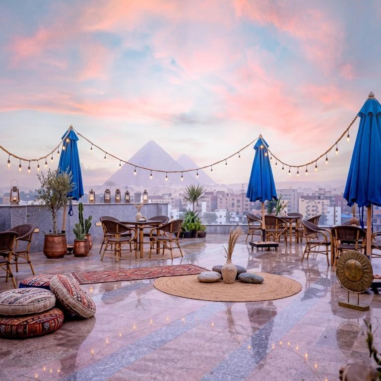 a view of the pyramids from the roof of a building at Blue Pyramids Eyes Hotel in Cairo