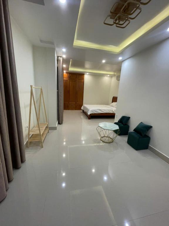 a living room with a bed and a white floor at Home Me 2 in Dong Hoi