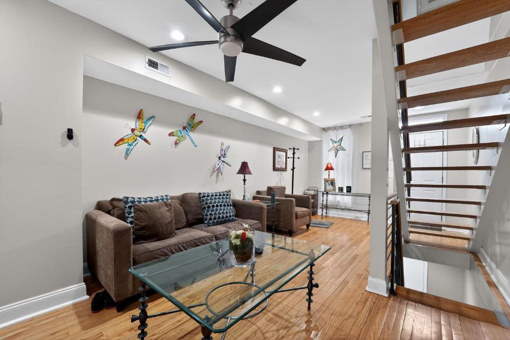 a living room with a couch and a glass table at Baltimore premier townhouse in Baltimore