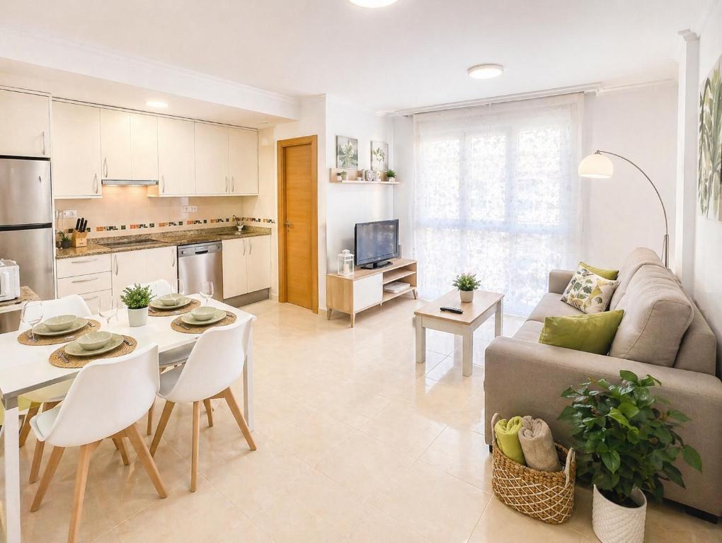 a kitchen and living room with a couch and a table at APARTAMENTO SOL in Viveiro