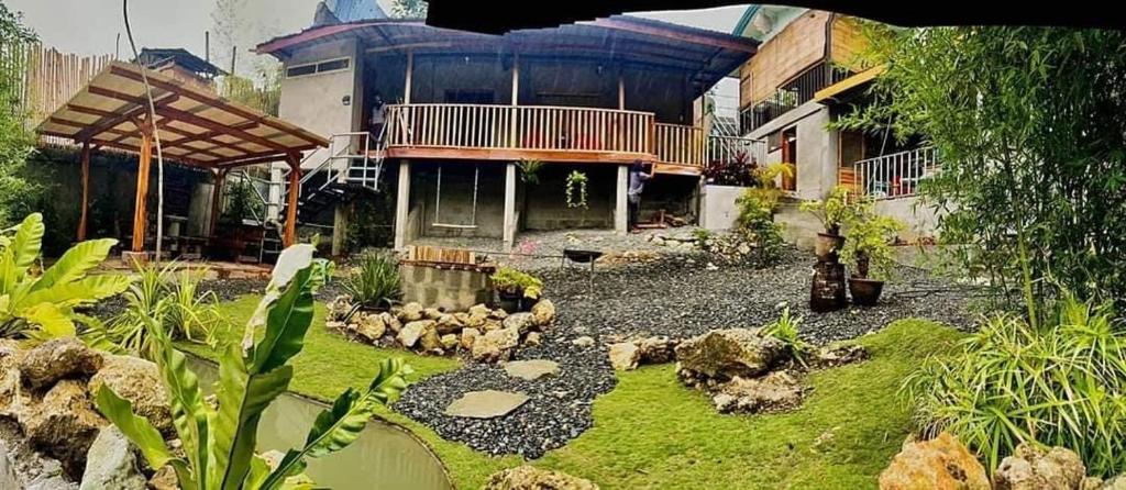 a garden in front of a house with a building at Cloudrest Marilog in Kayagan