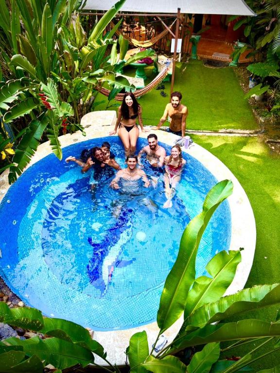 a group of people in a swimming pool at Cool Vibes Beach Hostel in Dominical