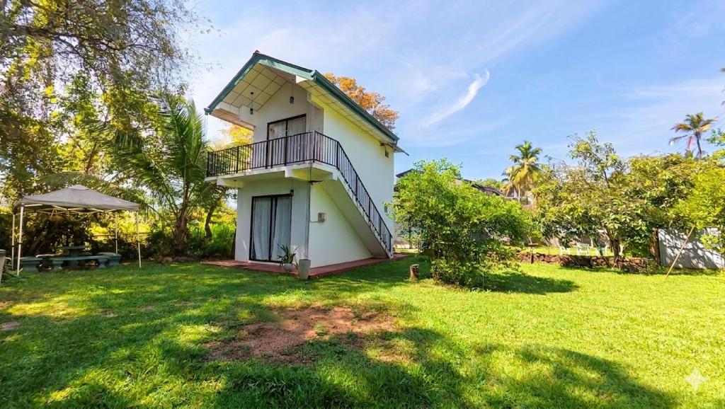 a house with a lawn in front of it at Sewana Cottage in Kurunegala