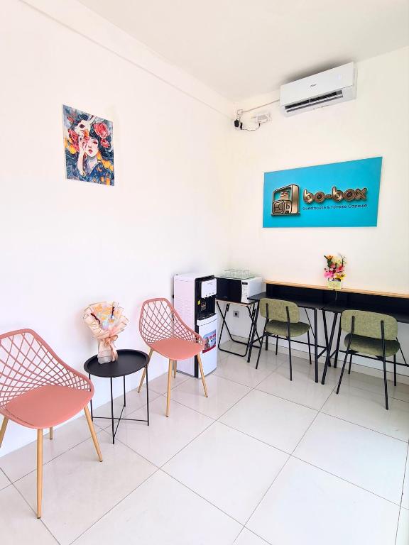 a waiting room with chairs and a piano at Bo-Box Guesthouse & Female Only Capsule Lempuyangan - Khusus Wanita in Yogyakarta