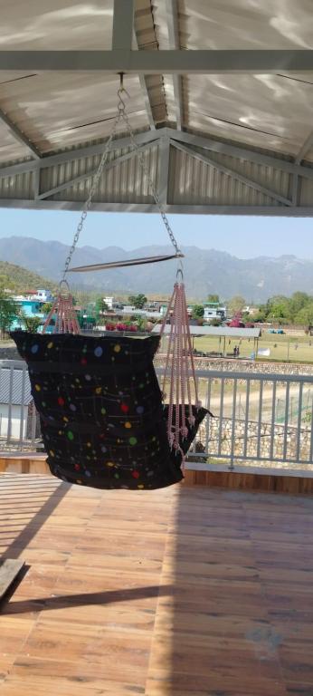a hammock hanging from awning on a pier at Aura by bala in Dehradun