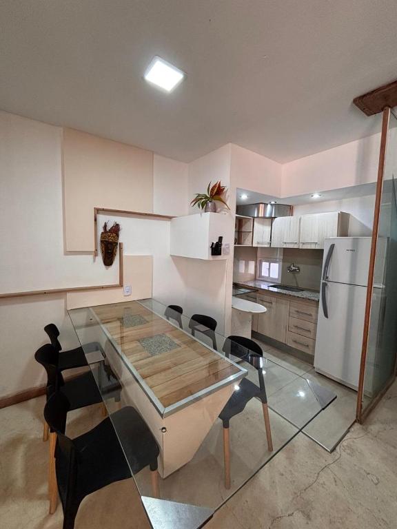a kitchen with a glass table and chairs and a refrigerator at Loft in La Rioja