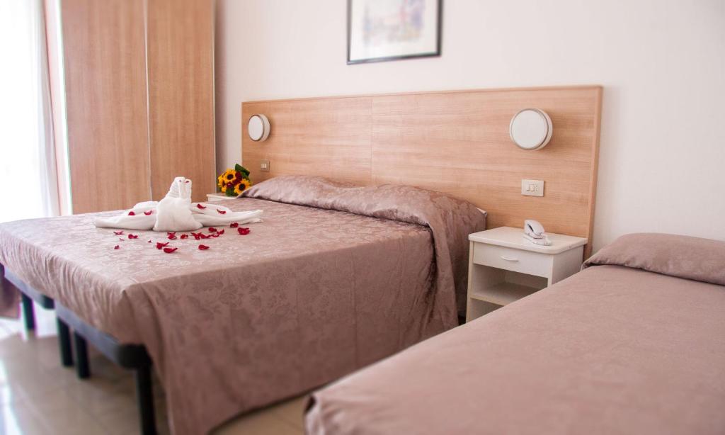 Postel nebo postele na pokoji v ubytování Hotel Raffaello