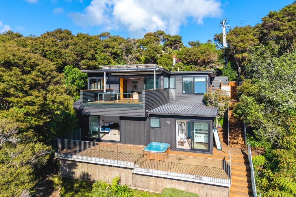 an aerial view of a house with a deck at Hekerua Heights with Hot Tub and Seaviews in Oneroa