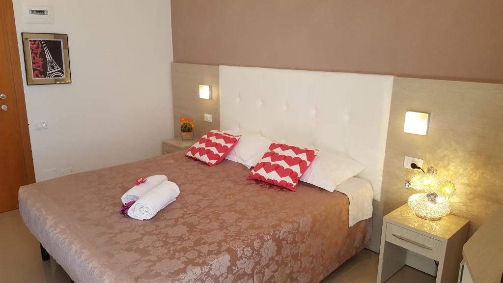 Postel nebo postele na pokoji v ubytování Hotel Raffaello