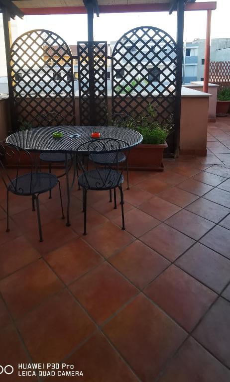 a table and chairs sitting on a patio at Salentini house in Lecce