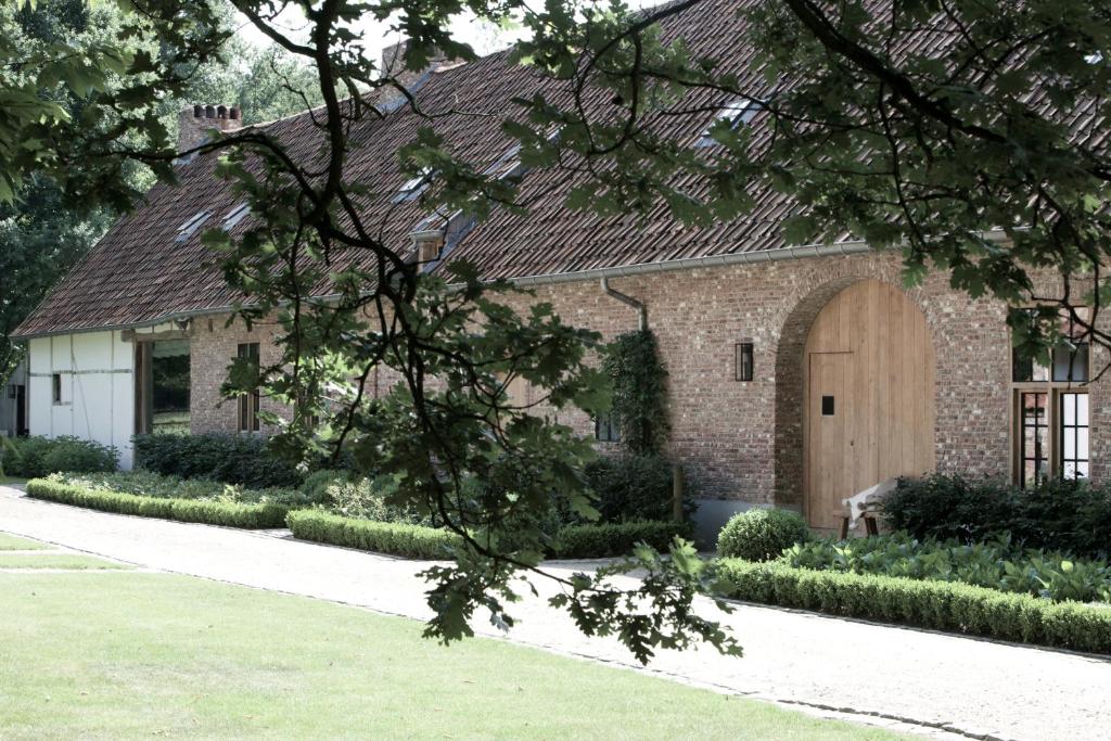 a brick house with a large wooden door at Moka & Vanille in Heusden - Zolder