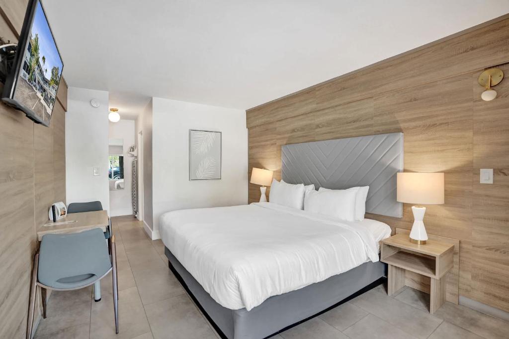 a hotel room with a large bed and a television at King Suite at Ocean Blvd in Fort Lauderdale