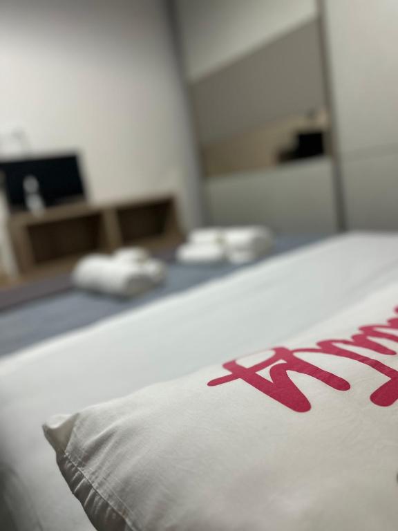 a pillow sitting on a bed in a room at Itria Charme Suite in Reggio di Calabria