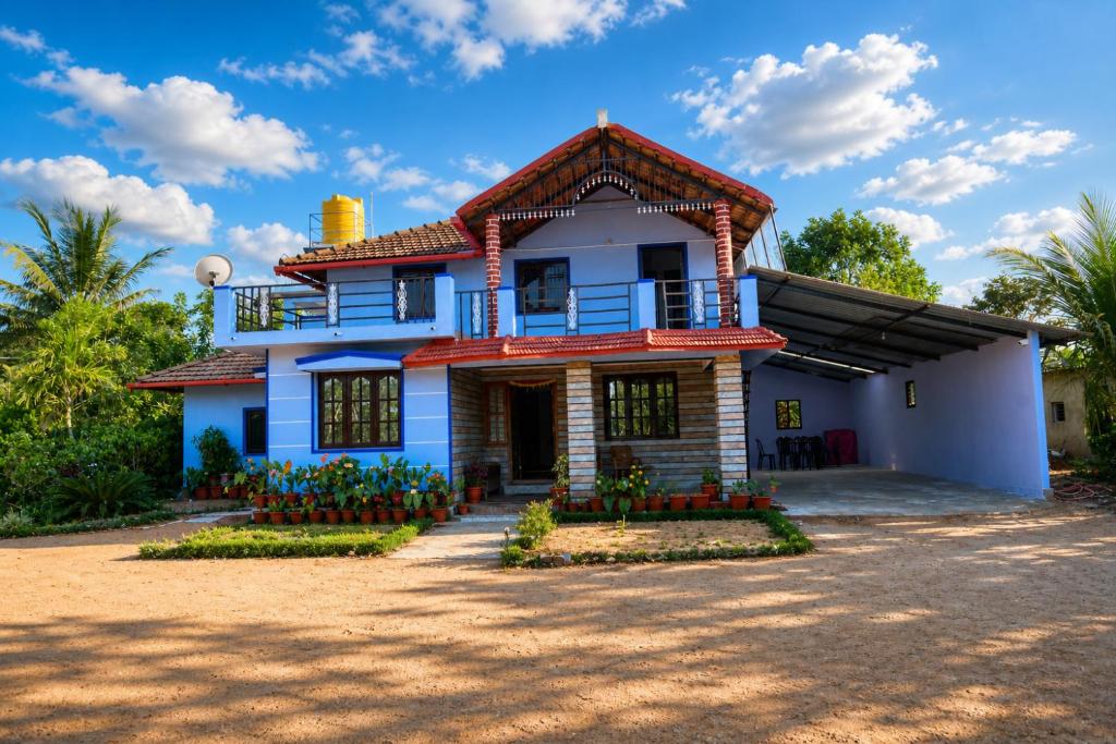 a blue house with a red roof at SugarLeaf Homestay - Home Food & Near to Tourist Places in Sakleshpur