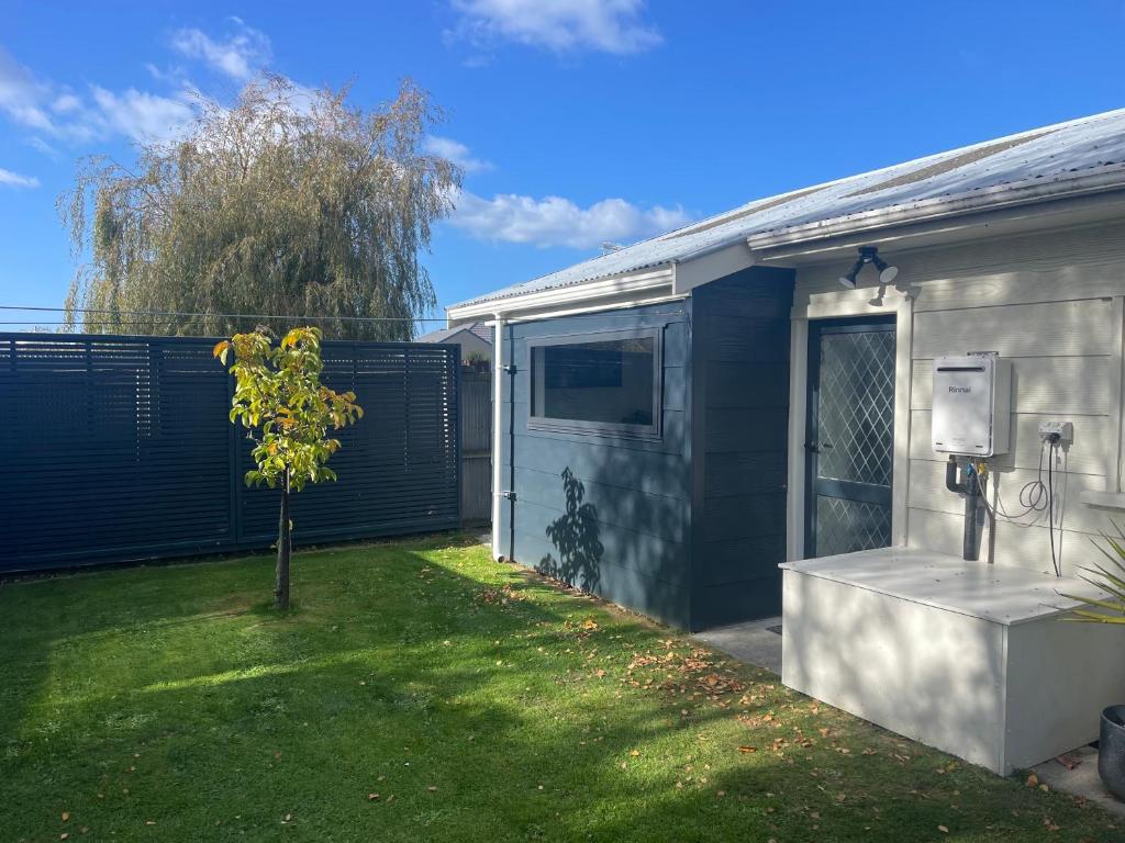a house with a small tree in the yard at Kaiapoi Village Le Shack in Kaiapoi