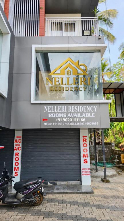 a motorcycle parked in front of a building at Nelleri Residency ROOMS STARTING AT 999 in Iritti